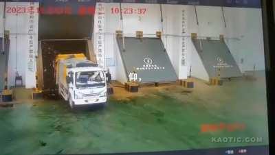 Garbage truck tips over while unloading trash into landfill chute