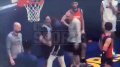 NBA player draymond Green knocking out teammate Jordan Poole in practice