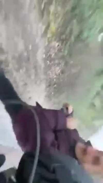 Ukrainian soldiers evacuating a Babushka under Grad-barrage.