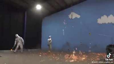 Hitting molten iron with a shovel