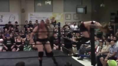 Addy Starr gets pushed onto the top turnbuckle by her male opponent