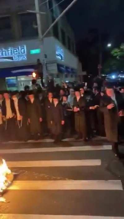 Orthodox Jews in Brooklyn, New York, set fire to a pile of face masks in protest of lockdown restrictions by New York Governor Cuomo