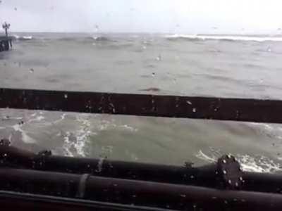 Big wave breaks through restaurant window (first person view)