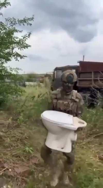 Ru pov: A Russian soldier performs a comedic skit poking fun at Ukrainians, jokingly suggesting that they always think that the Russian military has a reputation for stealing toilets.