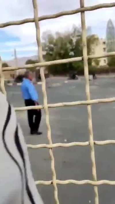 University security tries to shield the students from IR force's bullets in Sannandaj