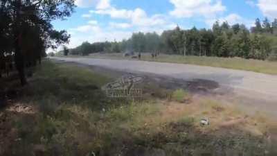 Ukrainian infantry assaulting Russian positions across a wooded area and road. The group of the SPD company of the separate center 