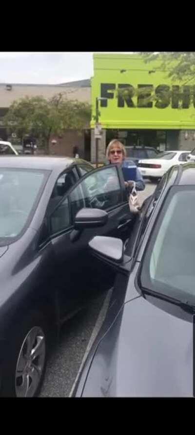Lady in Richmond, British Columbia yells racist slurs after being confronted for driving into the camera woman's parked car