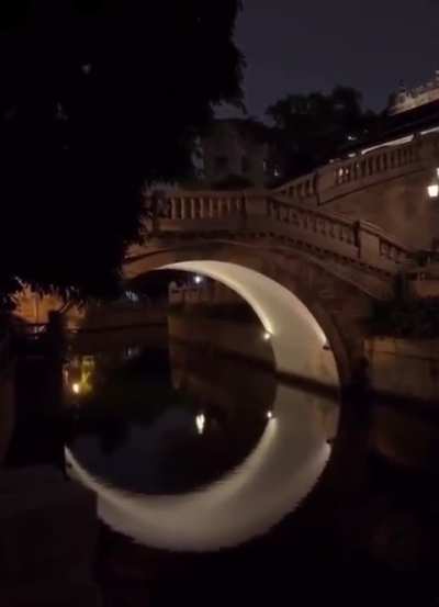 This lighting under this bridge makes it look like a crescent moon in the water, located in Guangzhou, China.