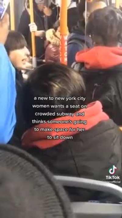 Woman demands seat on a packed train