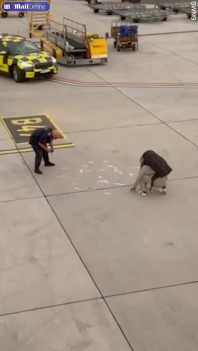 Woman throws £5,000 at man on airport runway after London-Bangkok flight diverted to Austria when she refused to pay for an upgrade