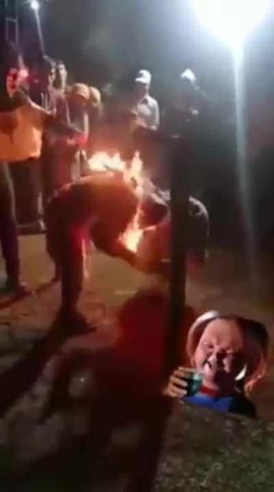 Men jumping through a fire hoop WCGW