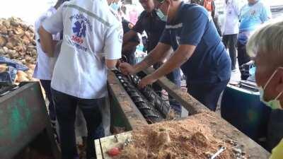 Worker rescued after getting hand stuck in coconut peeling machine.