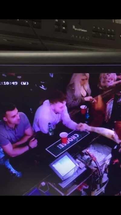 Man grabs a random bartender's hand and she makes him punch himself in the face