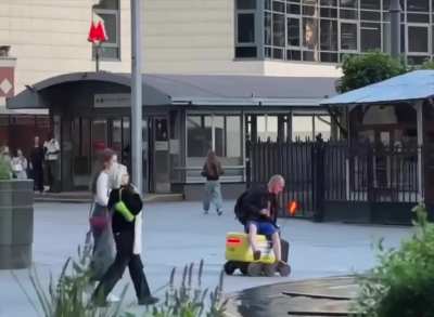 WCGW trying to ride a delivery robot.