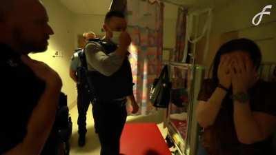 New Zealand police rescuing a child from anti-vax parents