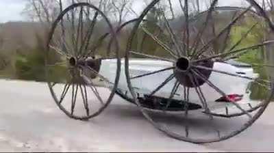 A Tesla with 10 foot wagon wheels