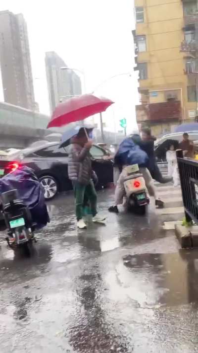 2 people kicking each other in the rain