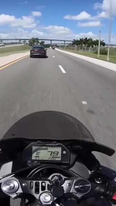 Police car brake checks a motorcycle