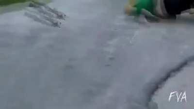 Fat scooter rider slams hard into the pavement after his failed stunt jump.