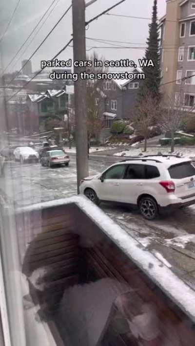 Parking your cars on an icy hill during a snowstorm in Seattle