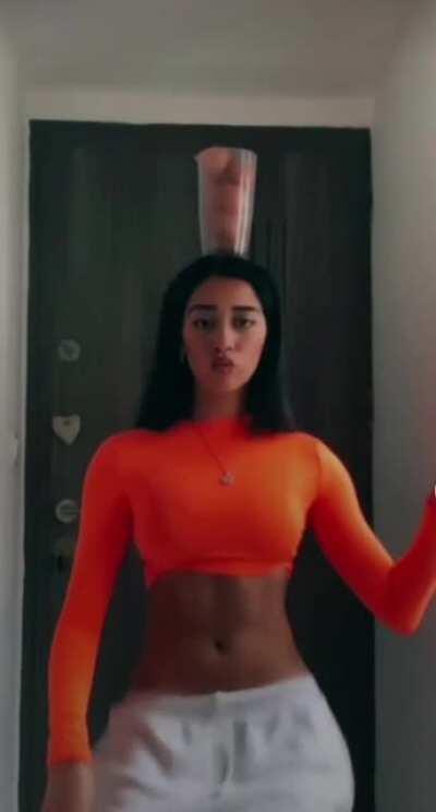 Practicing balancing skills while belly-dancing.