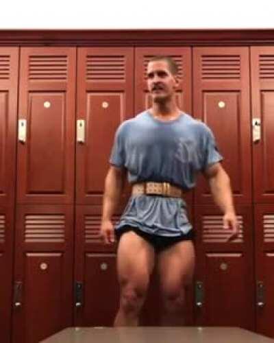 Random man cops a feel on a bodybuilder in a gym lockerroom.