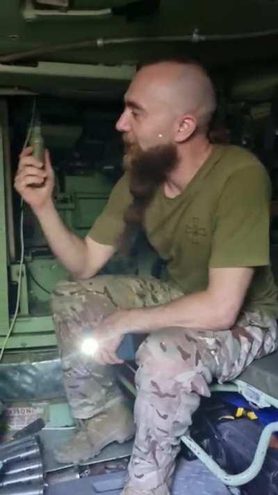 Curious George, Ukrainian soldier's guided tour of the Bradley fighting vehicle... braided beard no extra charge