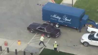 Cars driving on fresh concrete patch because the contractor didn't put any barricades.