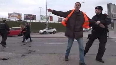 Activist slips on oil she spilled on the road