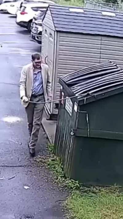 Bear trapped inside garbage bin