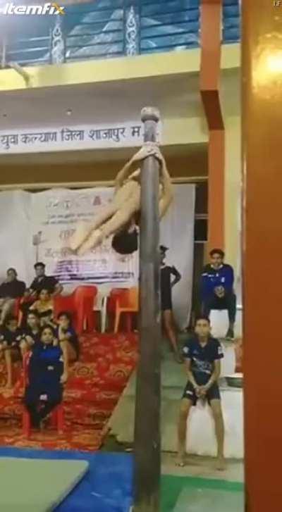Kid performing in a traditional Indian sport called Mallakamb