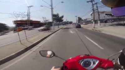 Guy takes his eyes off the road for a moment and ends up ramming scooter into the back of a VW Beetle.