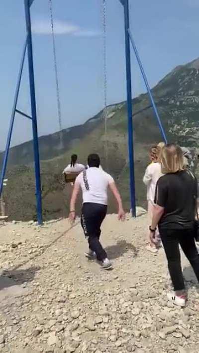 Swing, back and forth, wind in the hair... over a cliff