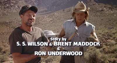 Kevin Bacon swinging a hammer in the movie Tremors.