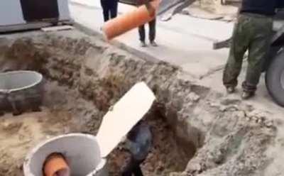 Using a piece of cardboard to direct the flow of concrete