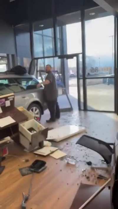 Man crashes car into dealership showroom due to overcharge.