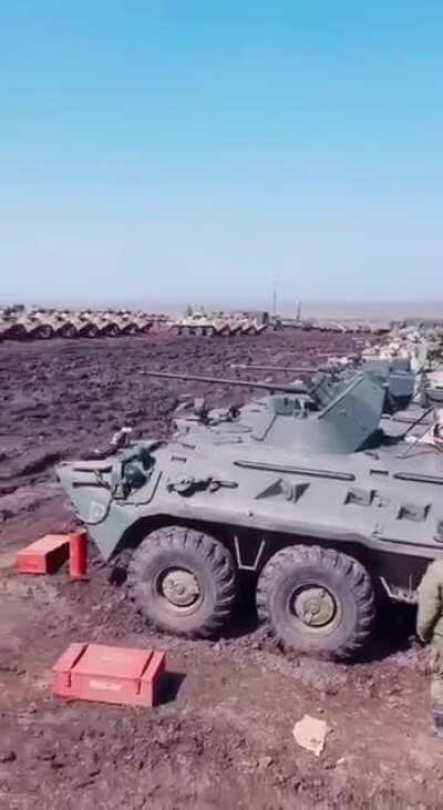 Russian BTR-82 in different colors somewhere in the field close to the border with Ukraine