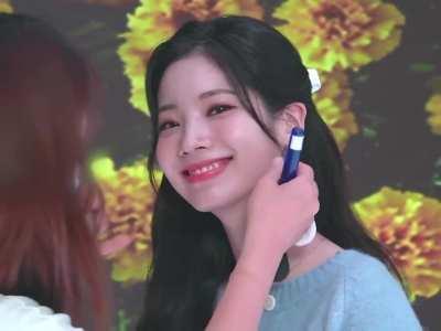 Dahyun smiling and waving