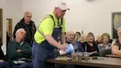 A farmer in Nebraska asking a pro-fracking committee member to honor his word of drinking water from a fracking location