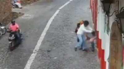 Guy tries to steal a woman's purse next to her husband