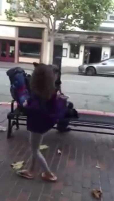 Young girl gives her food to a homeless person on the street