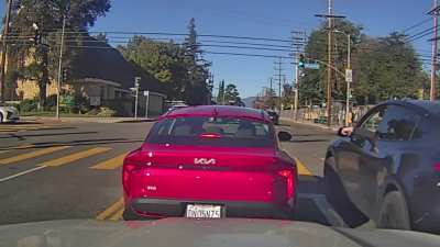 Car takes a left turn from the right lane.