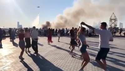 Moscow citizens dance against the backdrop of a blazing fireworks warehouse