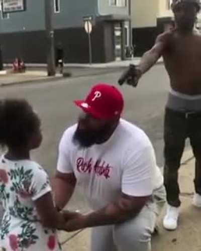 This father is rapping to his daughter while a dude behind him sings and points a gun at them. Idk if its more r/WTF but damn bro