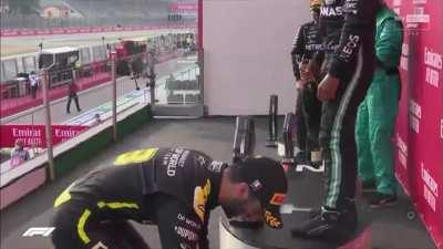 Ricciardo with his signature 'Shoey' after he forgot it to perform it last time in Germany