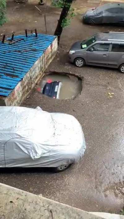 Sinkhole gobbled up a car in Mumbai, India last week during ongoing rains.