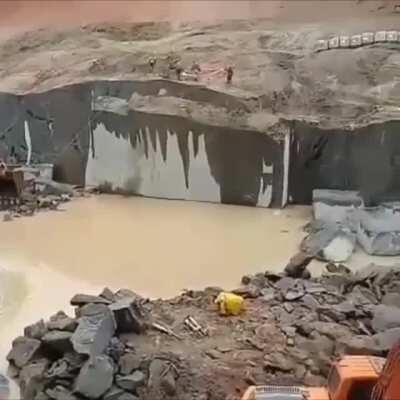Excavator pulling a slab out