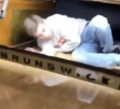 Idiot messing with the bowling ball machine