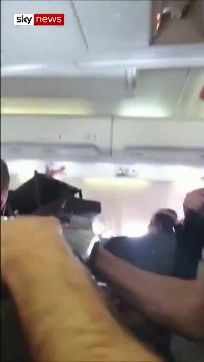 This is the moment a flight attendant was thrown to the ceiling of the plane after violent turbulence