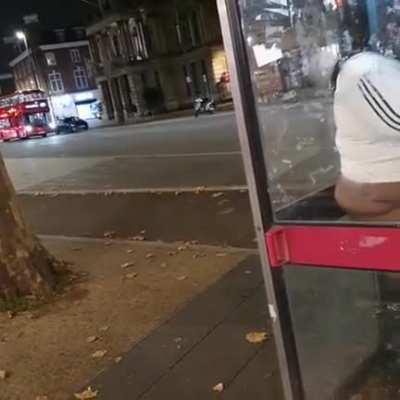 Classy lady taking a shit in a phone booth...